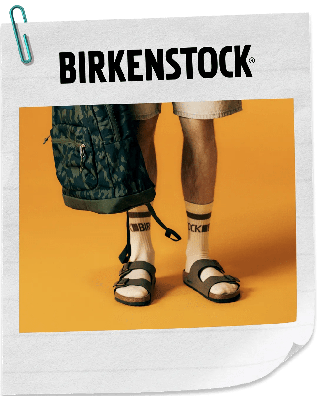 Featuring a male's leg wearing calf socks and Birkenstocks.
