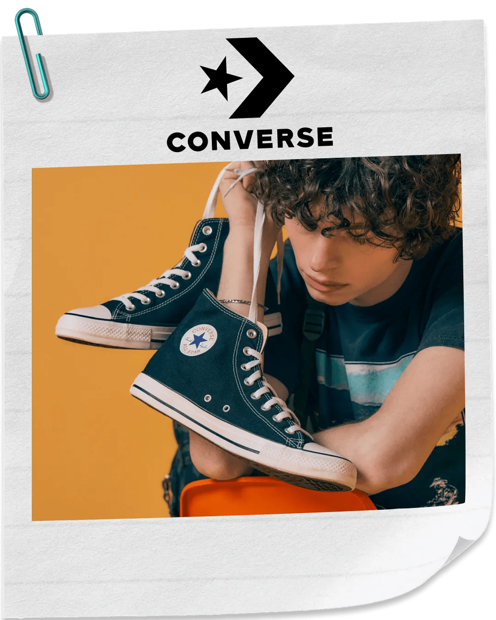 Featuring a male model with a pair of black converse.