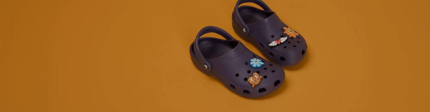 Black crocs with a variety of jibbitz on them.