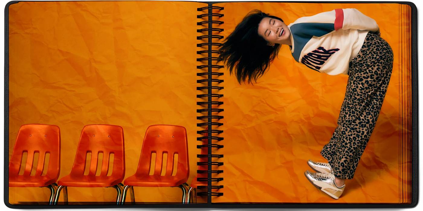 Featuring a young girl bending over 90 degrees showing off some metallic sneakers and smiling.